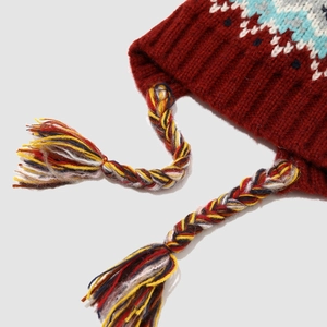 Detail of Fair Isle knit winter hat with colorful braids and geometric patterns