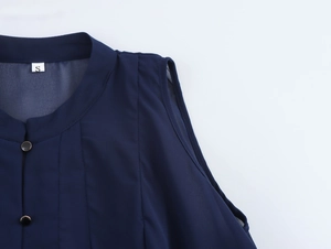 Detailed view of dark blue sleeveless chiffon top with standing collar and gold buttons