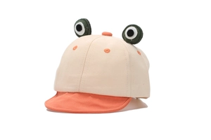 Detailed view of baby frog hat with 3D eyes and cotton canvas texture on white backdrop
