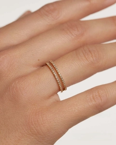 Detail of double gold-plated rings with pavé set crystals on a female finger