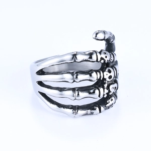 Macro detail of gothic stainless steel skeleton hand ring with vintage oxidized finish