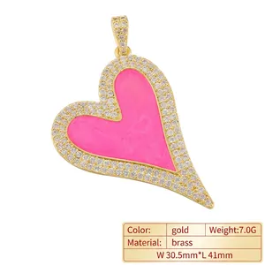 Pink enamel heart pendant with white crystals and gold plating in brass material