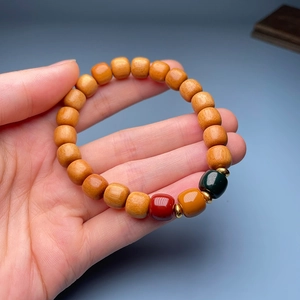 Close-up of sandalwood bamboo joint bracelet with colorful lotus accent beads