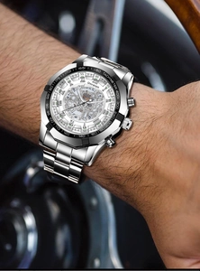 Detail of automatic mechanical watch with skeleton dial on wrist with wooden steering wheel
