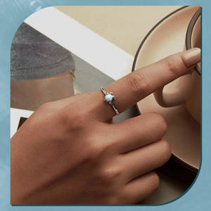Lifestyle view of a blue sea turtle S925 sterling silver ring worn on a finger