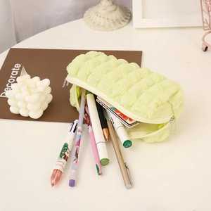 Detailed top view showing a large capacity light green bubble pencil case open with pens