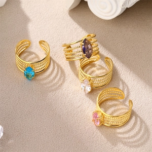Detail of 18K gold plated rings with colorful marquise-cut zircons and beaded bands
