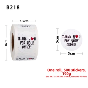 Macro detail of 5cm round Thank You stickers with black text and red heart on roll