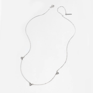 Detailed macro shot of an S925 sterling silver necklace featuring three heart pendants