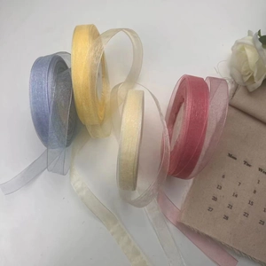 Detail of 2cm sheer organza ribbons in purple, yellow, cream, and pink for gift wrapping