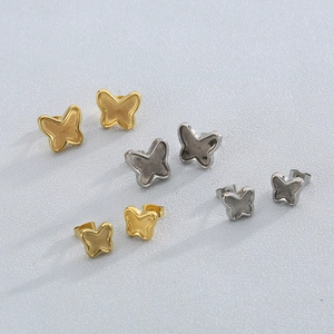 Elegant butterfly stud earrings in gold and silver stainless steel finish on white background