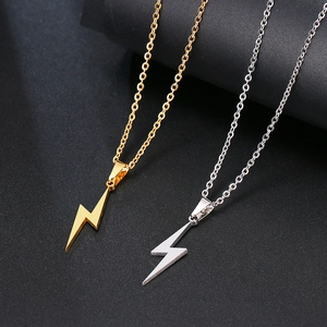 Minimalist lightning bolt pendant necklaces in gold and silver finish on matte background