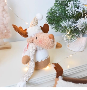 Detailed view of plush Christmas reindeer ornament with warm LED lights and soft knit scarf