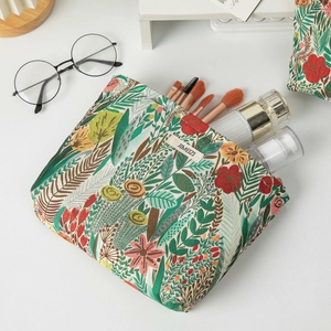Floral embroidered large capacity makeup bag showing spacious interior with beauty products