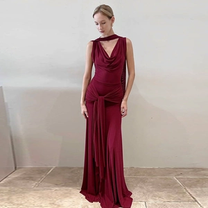 Detail of burgundy backless mesh dress with draped neckline and elegant waist tie knot