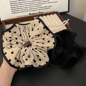 Elegant oversized polka dot scrunchie in black and cream velvet with leather trim edge