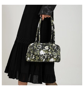 Detail of black shoulder bag with skull and floral print on high-quality nylon fabric