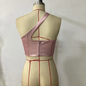 Pink satin one-shoulder crop top featuring an exposed back metal zipper and glossy finish
