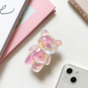 Detailed macro view of a 3D laser-effect bear phone grip with sparkling glitter filling