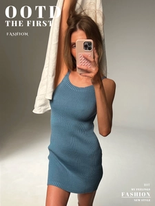 Close-up of blue ribbed knit dress fabric showing vertical texture and bodycon fit