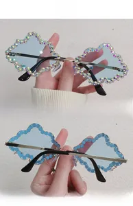 Detailed close-up of cloud-shaped sunglasses with aurora rhinestones and gold metal arms