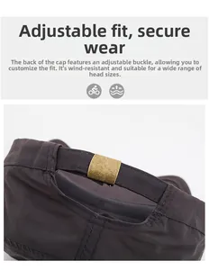 Macro detail of adjustable bronze metal buckle and fabric strap on a dark sun cap