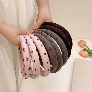 Padded headband with black polka dot bow and heart patterns in pink, grey and black colors