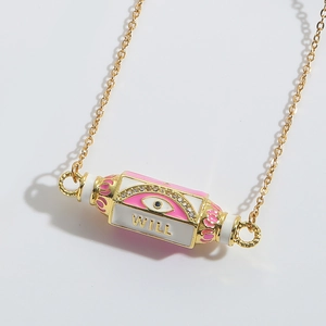 Close-up of pink enamel Evil Eye pendant with gold WILL engraving and zircon detail