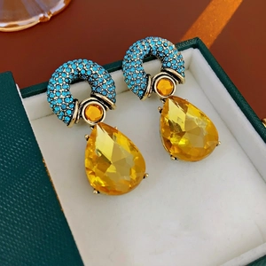 Vintage gold teardrop earrings with blue pavé diamonds and yellow faceted crystal drops