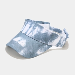 Detail of blue and white tie-dye sun visor hat with adjustable strap for outdoor protection