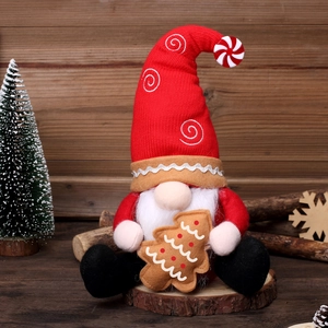 Red Nordic Christmas gnome plush holding a gingerbread tree on a wooden base decor