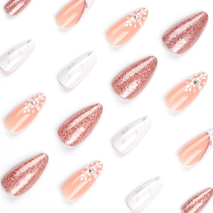 French almond press-on nails with rose gold glitter, marble patterns, and snowflake designs