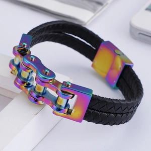 Close-up of a men's woven leather bracelet with a vibrant rainbow metal chain detail