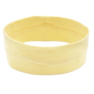 Detail of yellow elastic yoga headband showing breathable cotton fabric and wide band design