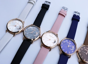 Close-up of five colorful quartz watches featuring moon star dials and leather straps