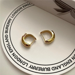 Minimalist gold-plated C-shaped hoop earrings with a small pink zircon gemstone inlay
