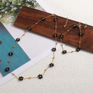 18K gold plated daisy necklace and bracelet set with black beads and floral design