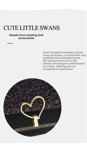Detail of golden heart-shaped twist lock on black glitter crossbody bag with embroidery