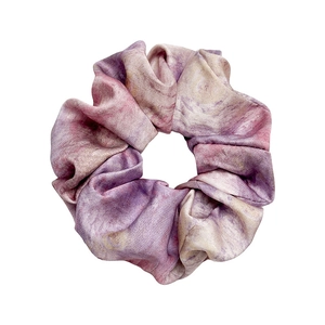 Tie-dye satin scrunchie with purple and pink marble pattern on a clean white background