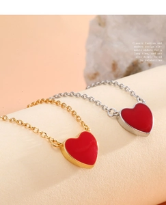 Close-up of red heart pendant necklaces in gold and silver finishes with macro detail