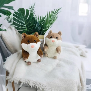 Cute stuffed guinea pig plush toys in brown and white colors on a soft white blanket