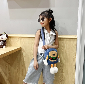 Close-up of a blue canvas cartoon burger crossbody bag with 3D soft limbs on a child