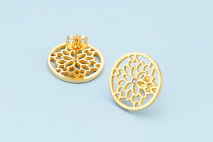 Detail of gold circular hollow earrings featuring a clear cubic zirconia center stone