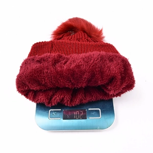 Detailed view of heavy knit beanie weight at 102g showing thick warm fleece lining