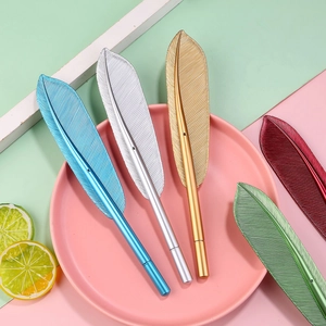 Five metallic feather-shaped pens in assorted colors on a modern geometric background