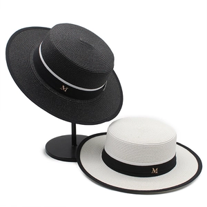 Hepburn style flat top boater straw hat with black edging and golden M letter decoration