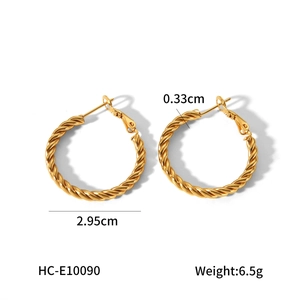 Detail showing 2.95cm diameter and 0.33cm width of golden twisted titanium steel hoop earrings