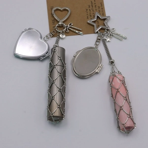 Detail of metal mesh lipstick holder keychain with heart mirror and star charms