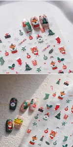 Detailed view of 3D embossed Christmas nail stickers with festive dog and tree motifs