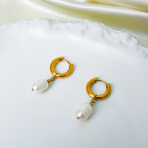 Close-up of 14K gold plated hoop earrings with baroque freshwater pearls on silk